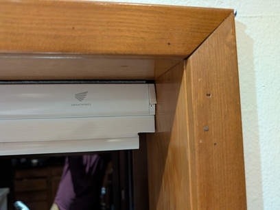 Custom-shaped motorized blind with special cut shown in open position